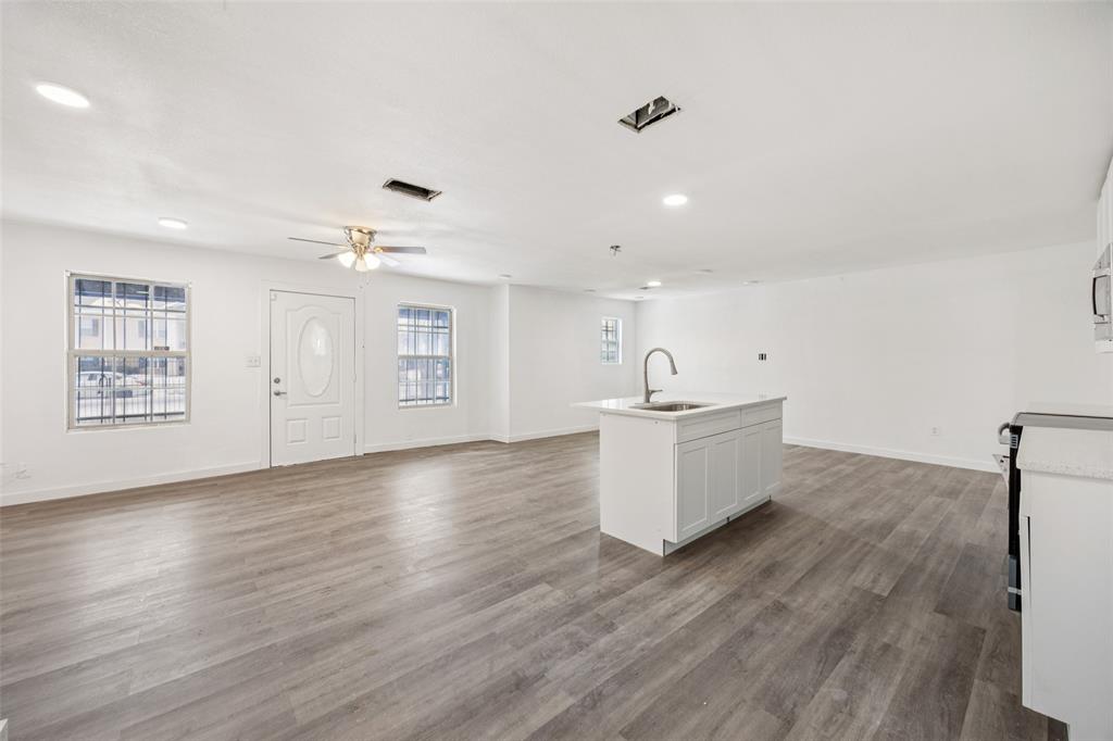 3847 Stalcup Road Fort Worth, TX 76119 - Photo 10 of 30 a view of an empty room with wooden floor and a window