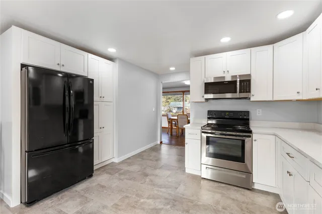 a kitchen with stainless steel appliances a refrigerator stove and microwave