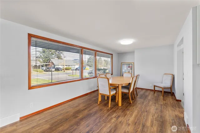 a dining room with furniture and wooden floor