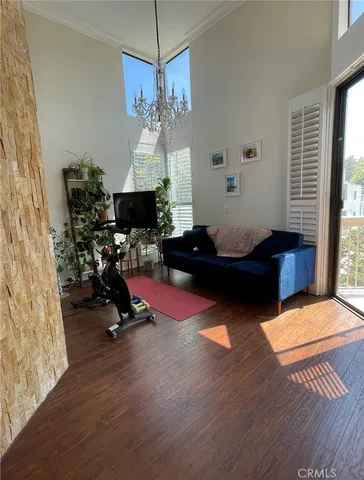 a living room with furniture chandelier and a window