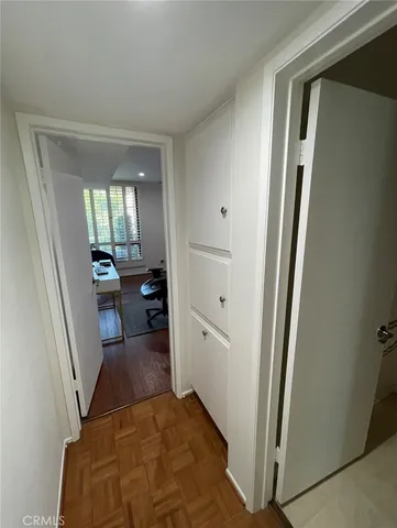a view of a hallway view with living room and wooden floor