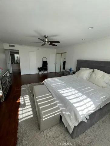 a bedroom with a bed and a night stand