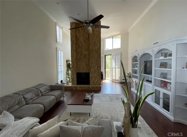 a living room with furniture and a book shelf