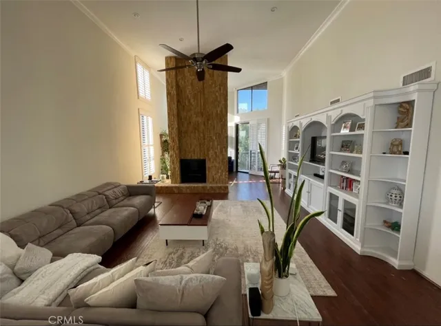 a living room with furniture fireplace and a window
