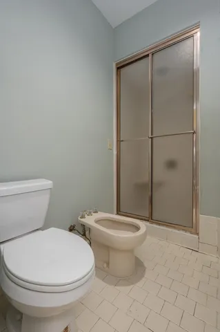 a white toilet sitting next to a bathroom sink