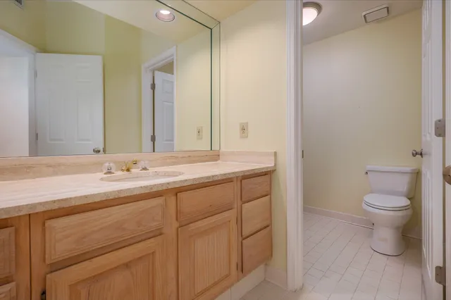 a bathroom with a sink a toilet and a mirror