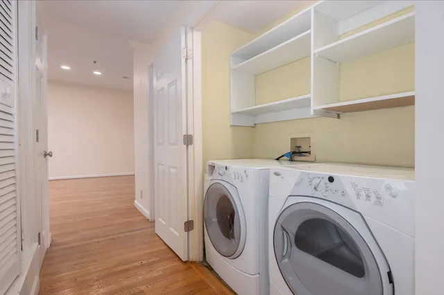 a view of a hallway with washer and dryer