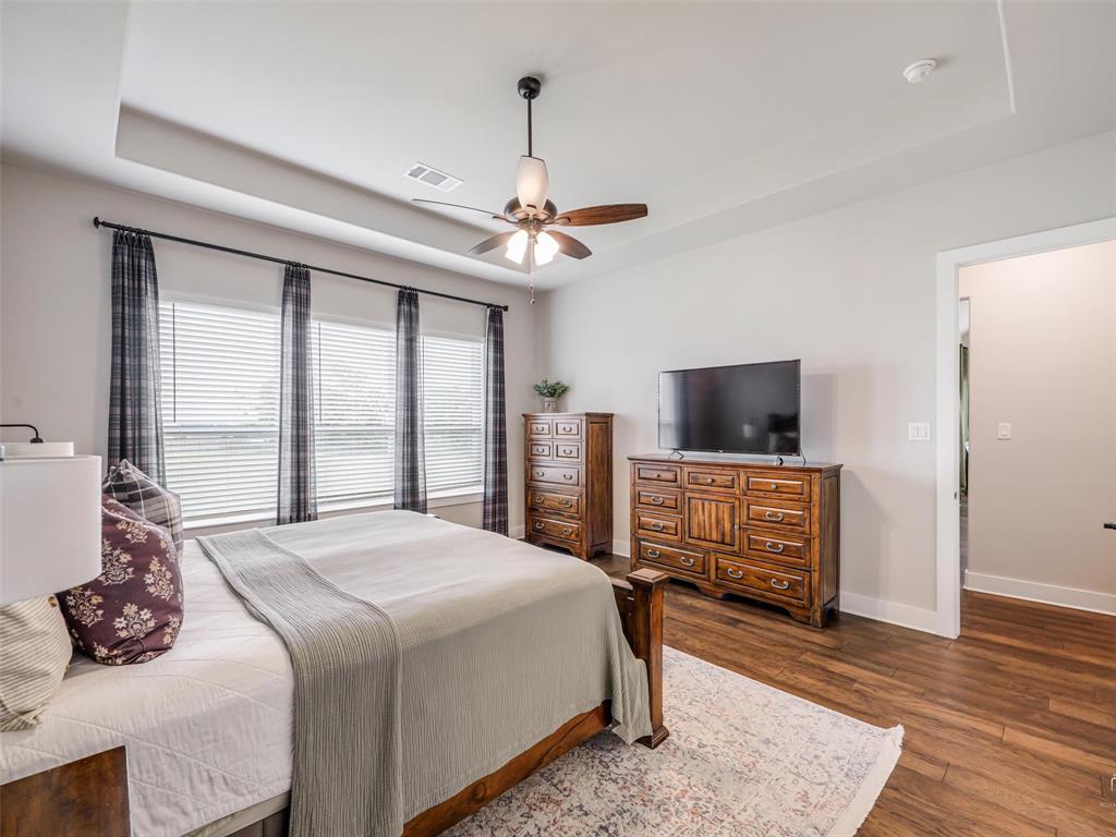 544 Majors Road Van Alstyne, TX 75495 - Photo 15 of 36 a bedroom with a bed a flat screen tv and a window