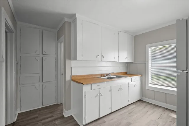 a kitchen with a sink and cabinets