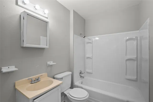a bathroom with a toilet sink and shower