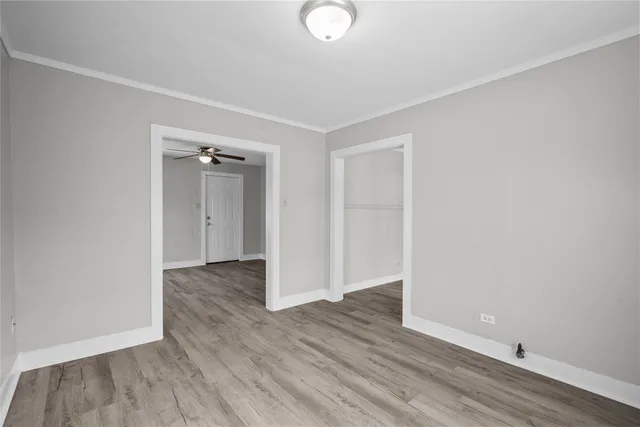 an empty room with wooden floor and closet