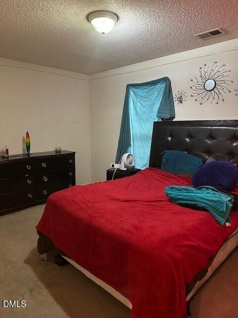 4801 Tanglewood Oaks Street Raleigh, NC 27610 - Photo 11 of 12 a bed sitting in a bedroom and dresser