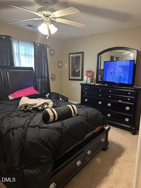4801 Tanglewood Oaks Street Raleigh, NC 27610 - Photo 9 of 12 a bedroom with a bed and a chandelier