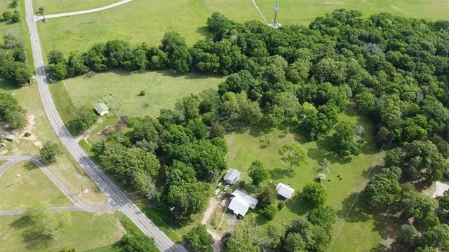 an aerial view of a house with a yard