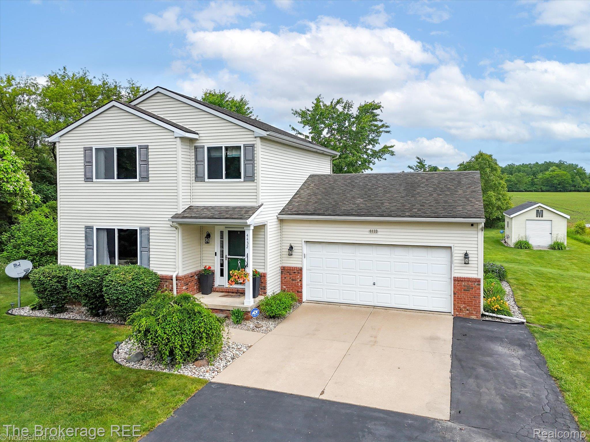 4432 North Belsay Road Flint, MI 48506 - Photo 1 of 79 Two-story residence featuring light-toned siding, dark shutters, and a covered front entry