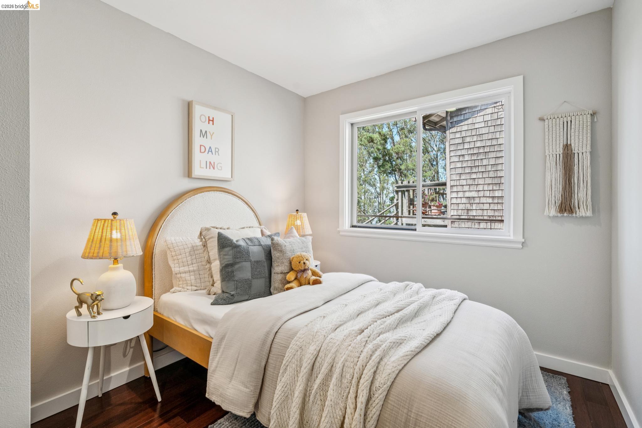 1394 Queens Road Berkeley, CA 94708 - Photo 53 of 63 Wood-finish flooring, light-toned walls, and a sliding window with white trim
