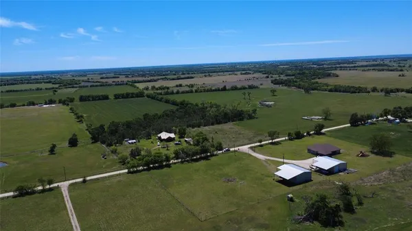 an aerial view of a house with a lake view