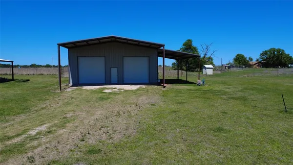 a view of a wooden house with a yard
