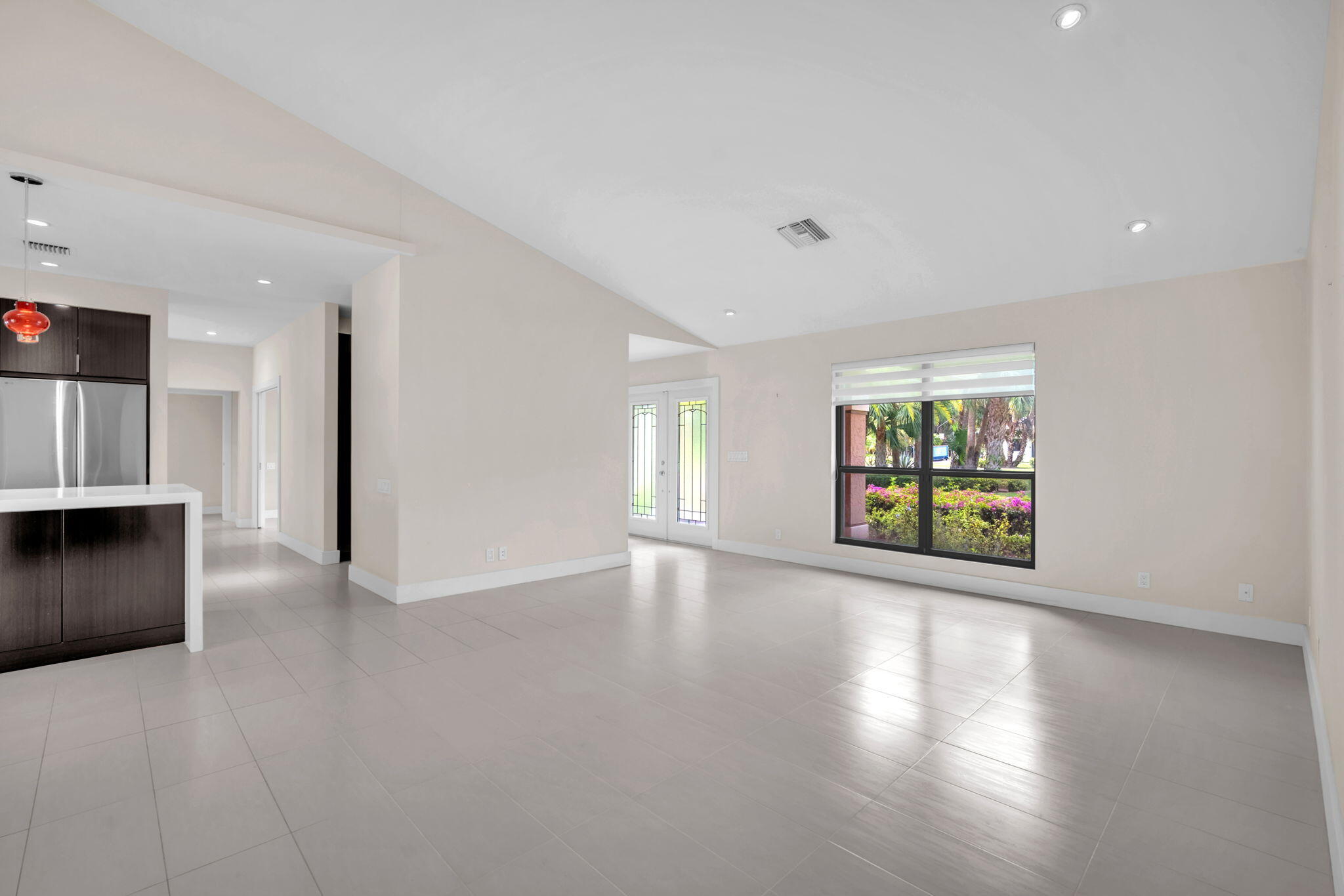 13759 Doubletree Trail Wellington, FL 33414 - Photo 27 of 76 a view of an empty room with wooden floor and windows