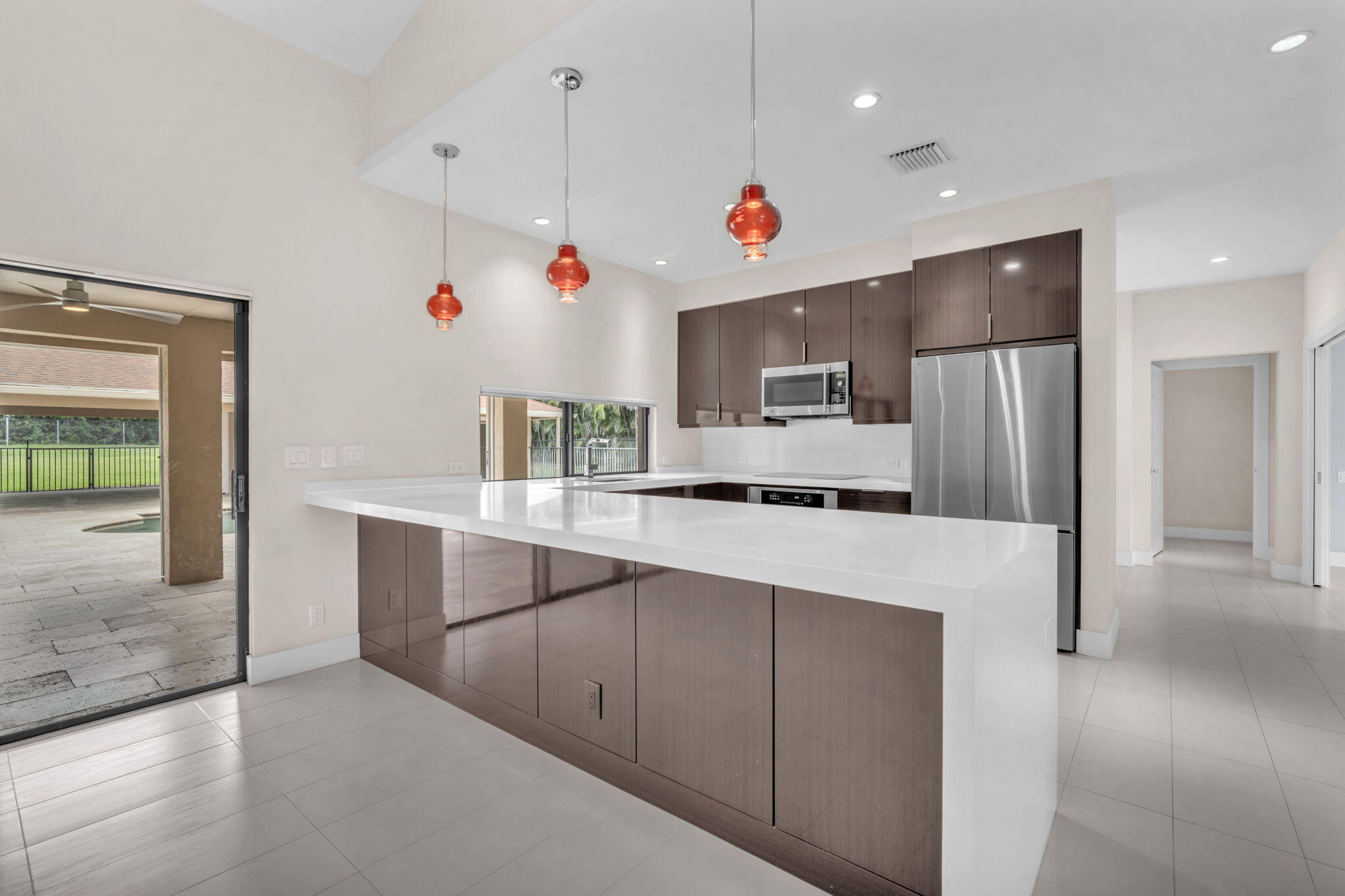 13759 Doubletree Trail Wellington, FL 33414 - Photo 30 of 76 a kitchen with white cabinets and refrigerator