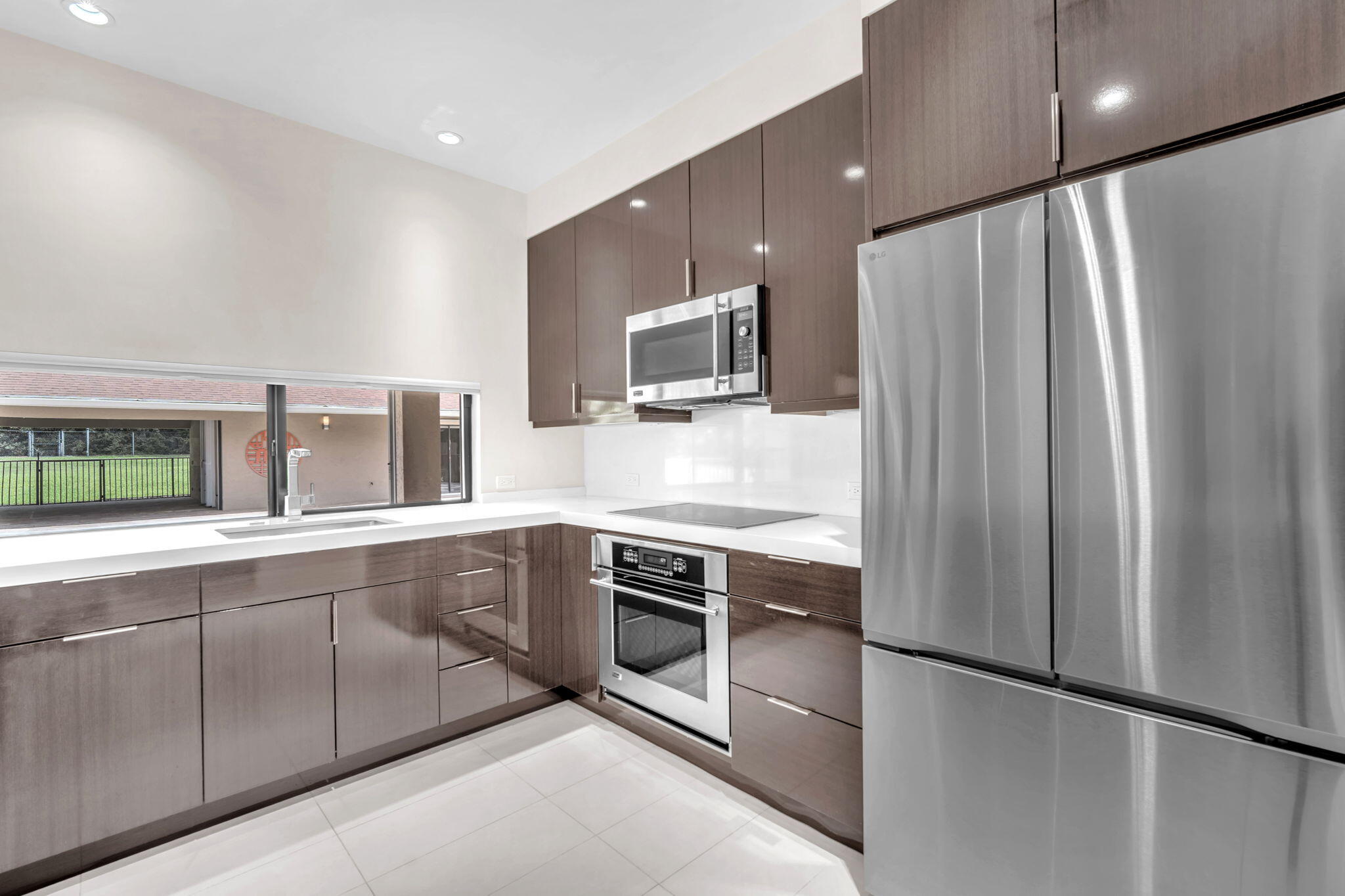 13759 Doubletree Trail Wellington, FL 33414 - Photo 32 of 76 a kitchen with stainless steel appliances granite countertop a refrigerator a stove and a sink