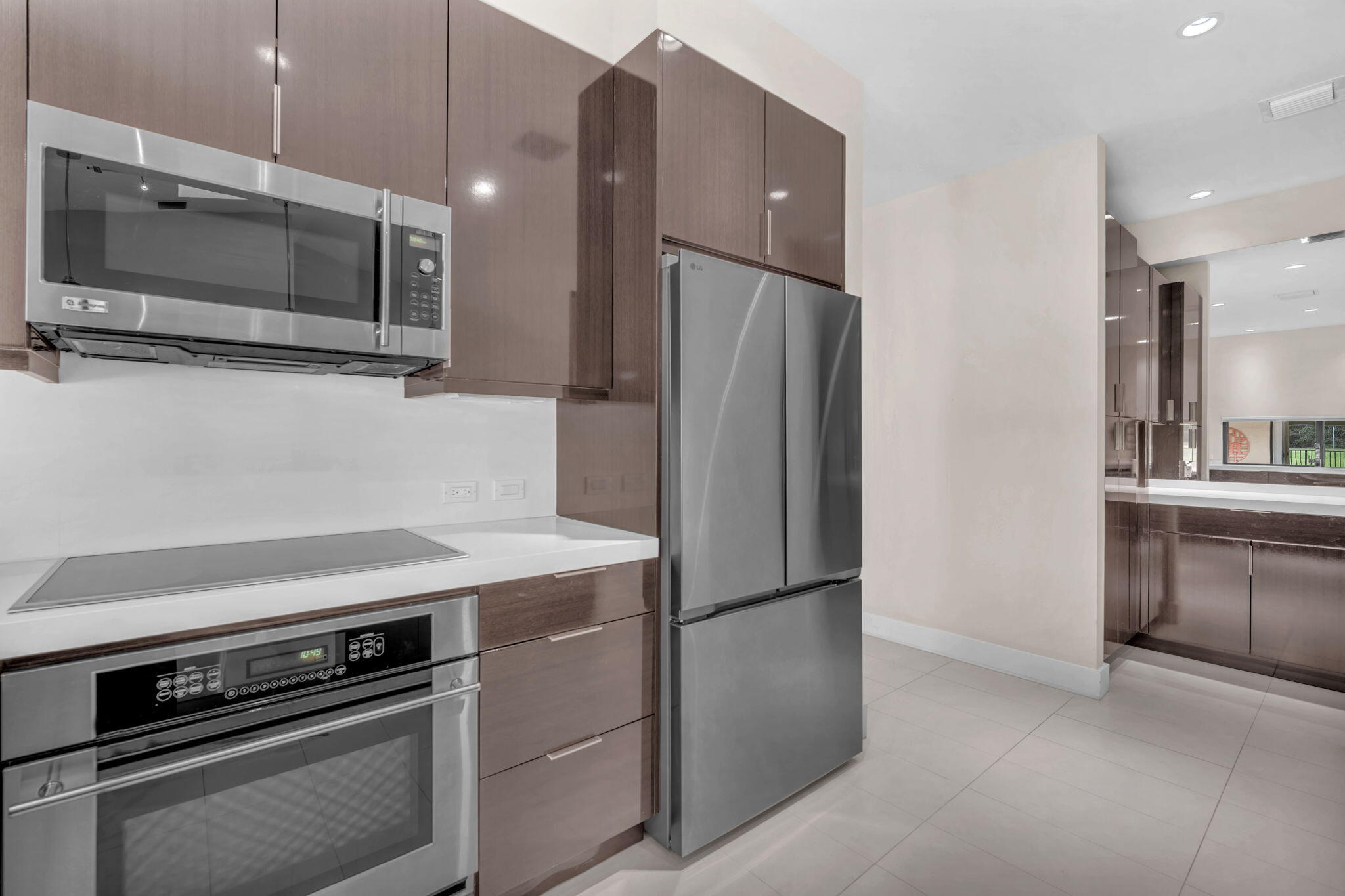 13759 Doubletree Trail Wellington, FL 33414 - Photo 34 of 76 a kitchen with a refrigerator and a microwave