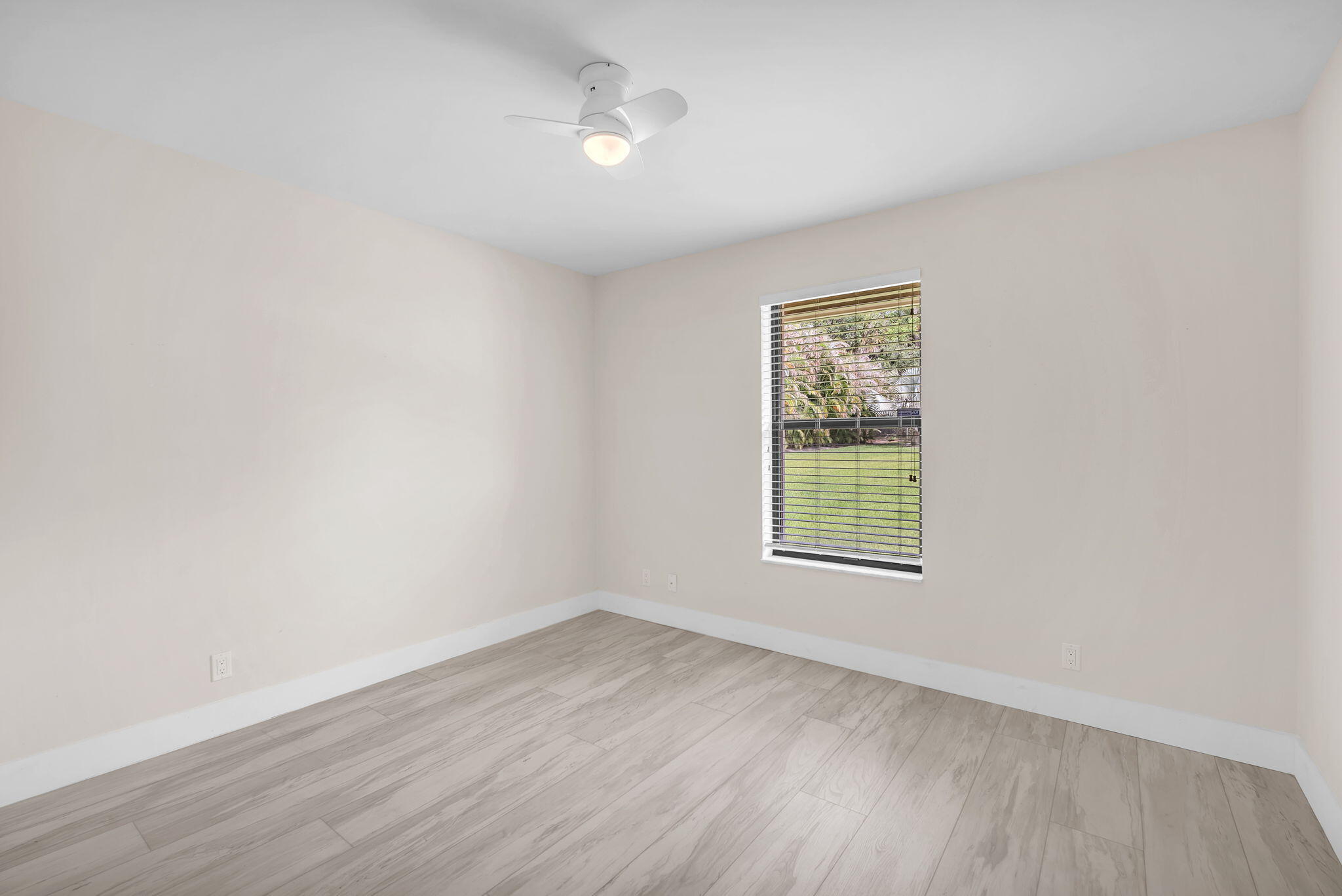 13759 Doubletree Trail Wellington, FL 33414 - Photo 47 of 76 wooden floor in an empty room with a window