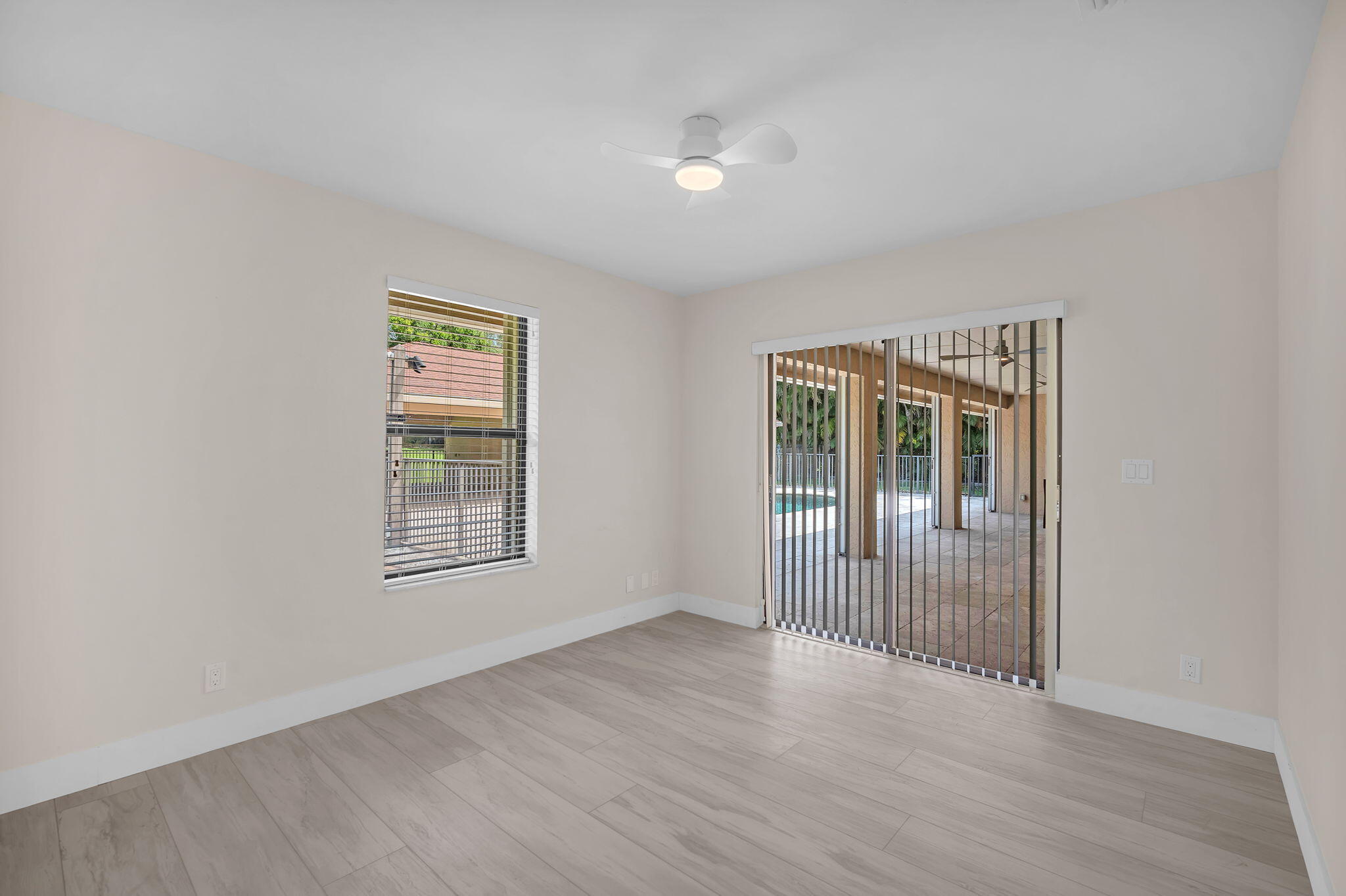 13759 Doubletree Trail Wellington, FL 33414 - Photo 49 of 76 an empty room with wooden floor and windows