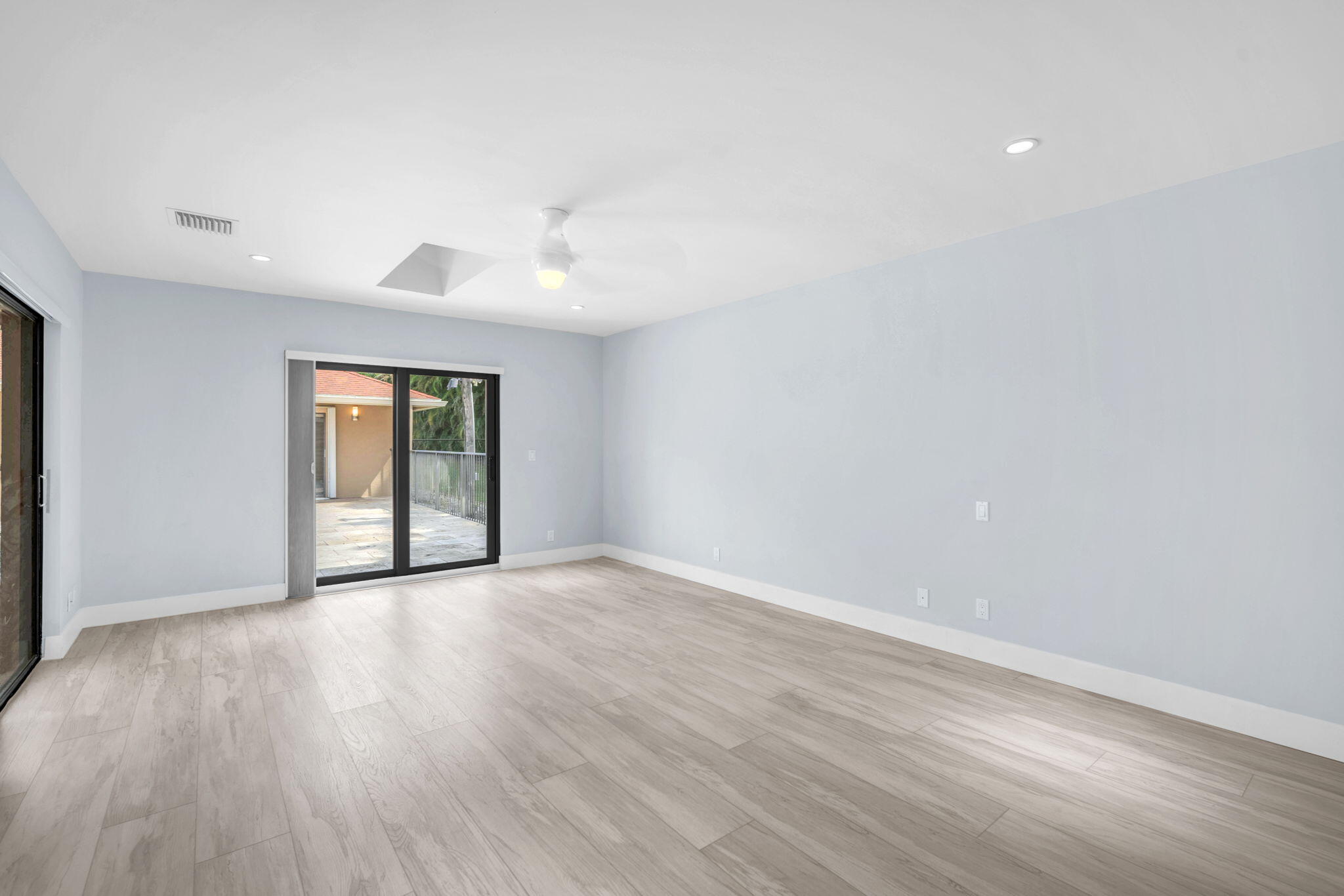 13759 Doubletree Trail Wellington, FL 33414 - Photo 52 of 76 a view of an empty room with wooden floor and a window
