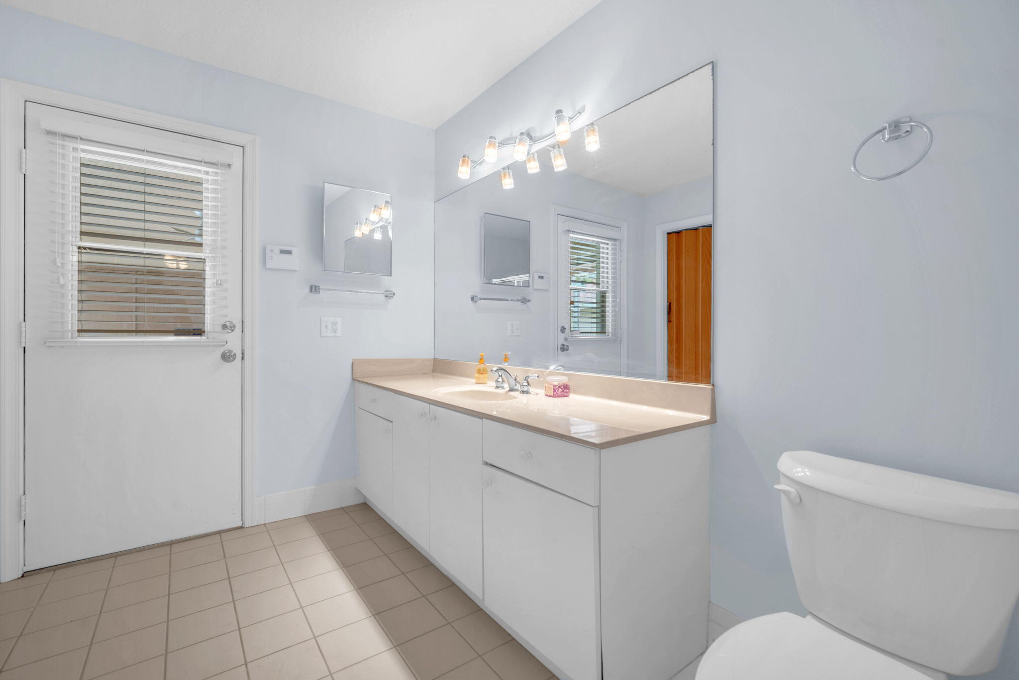 13759 Doubletree Trail Wellington, FL 33414 - Photo 69 of 76 a bathroom with a sink a toilet and mirror