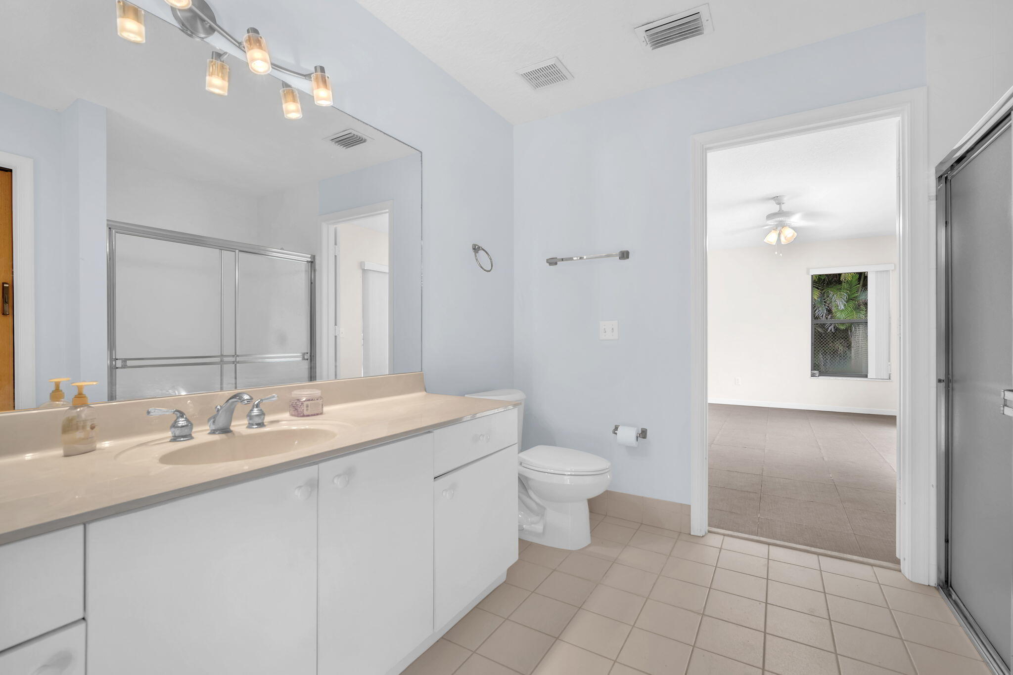 13759 Doubletree Trail Wellington, FL 33414 - Photo 70 of 76 a spacious bathroom with a granite countertop sink a toilet and a mirror