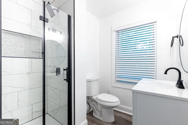 a bathroom with a toilet a sink and shower