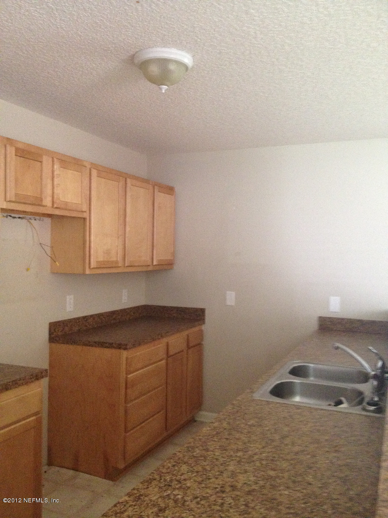 8227 Metto Road Jacksonville, FL 32244 - Photo 3 of 11 a room with a sink and cabinets