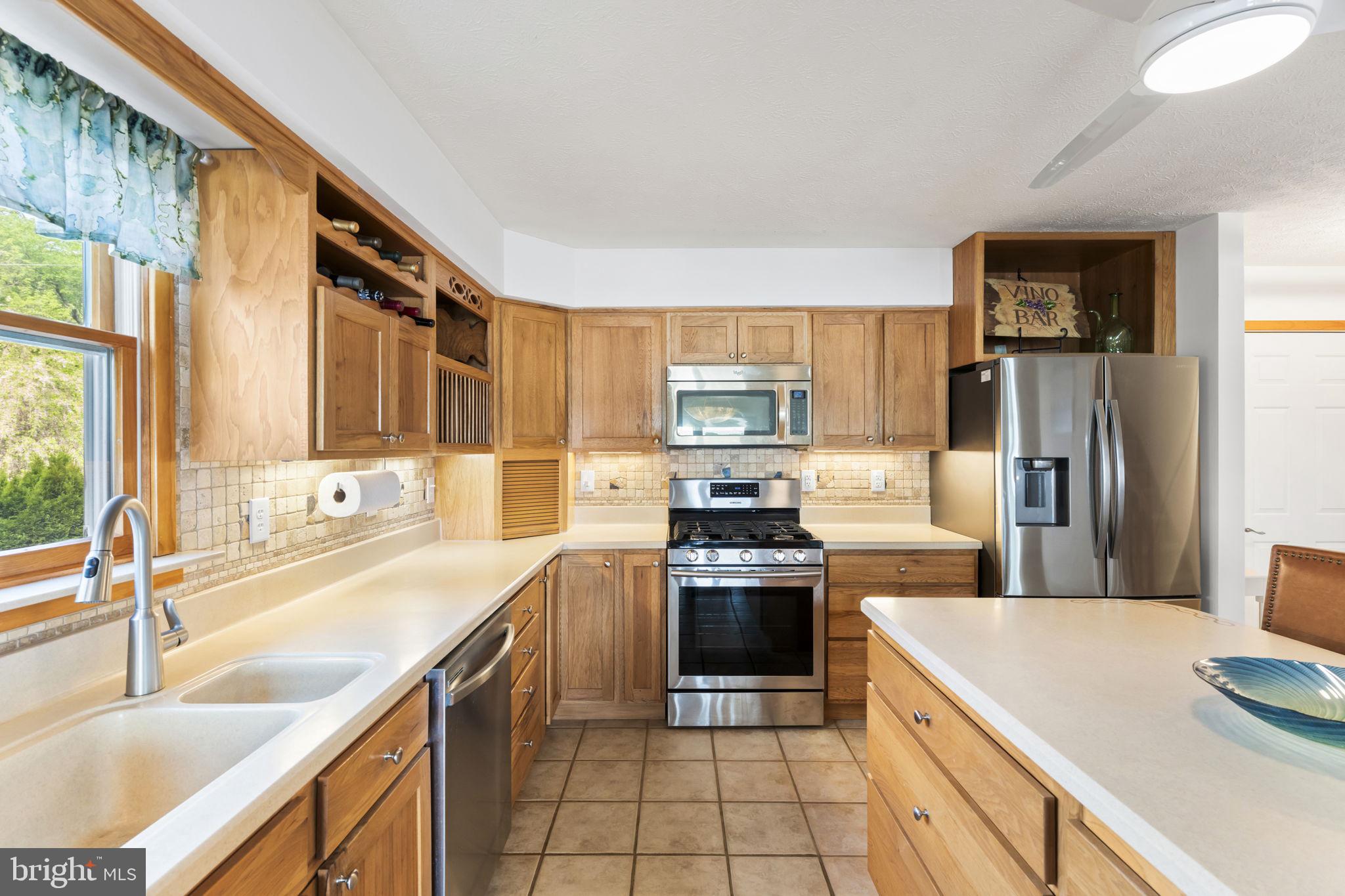 94 Crescent Lane Elkton, MD 21921 - Photo 12 of 59 a kitchen with stainless steel appliances granite countertop a sink stove and refrigerator