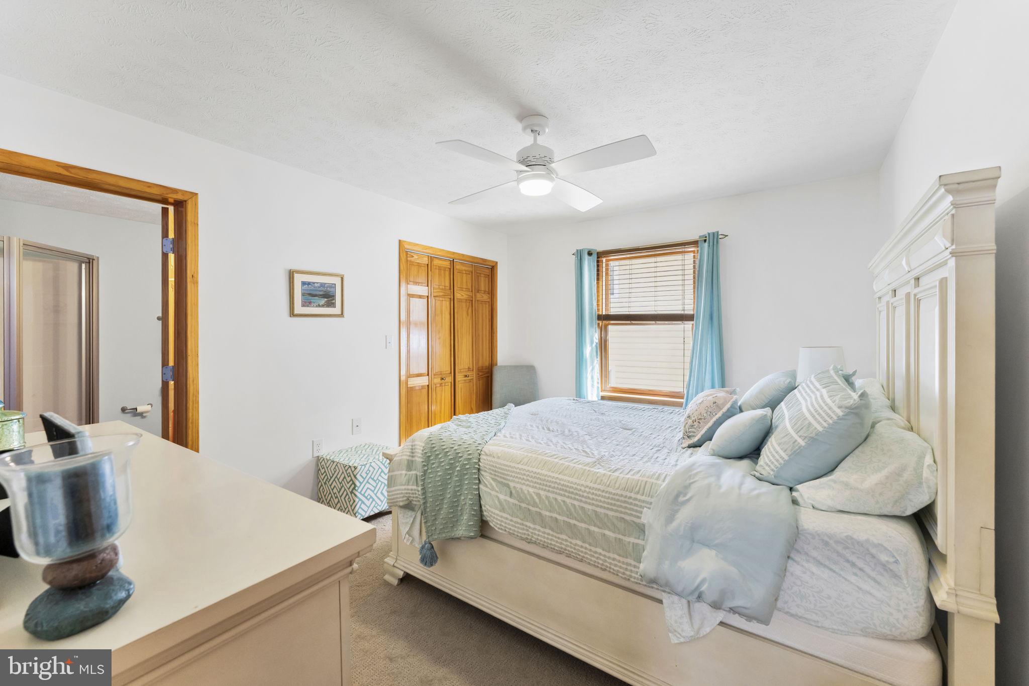94 Crescent Lane Elkton, MD 21921 - Photo 23 of 59 a bedroom with a large bed and a dresser