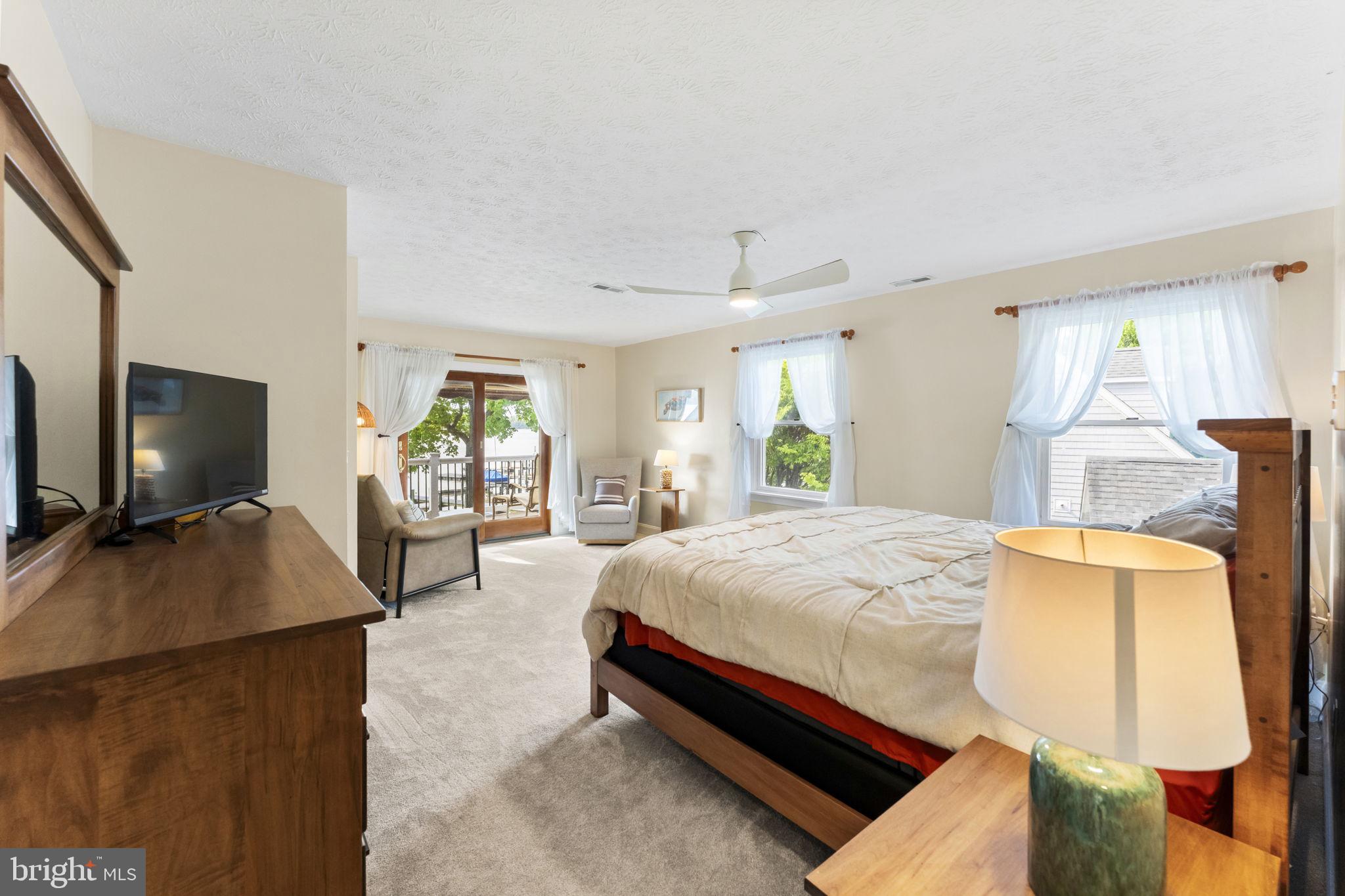94 Crescent Lane Elkton, MD 21921 - Photo 30 of 59 a spacious bedroom with a bed and glass windows