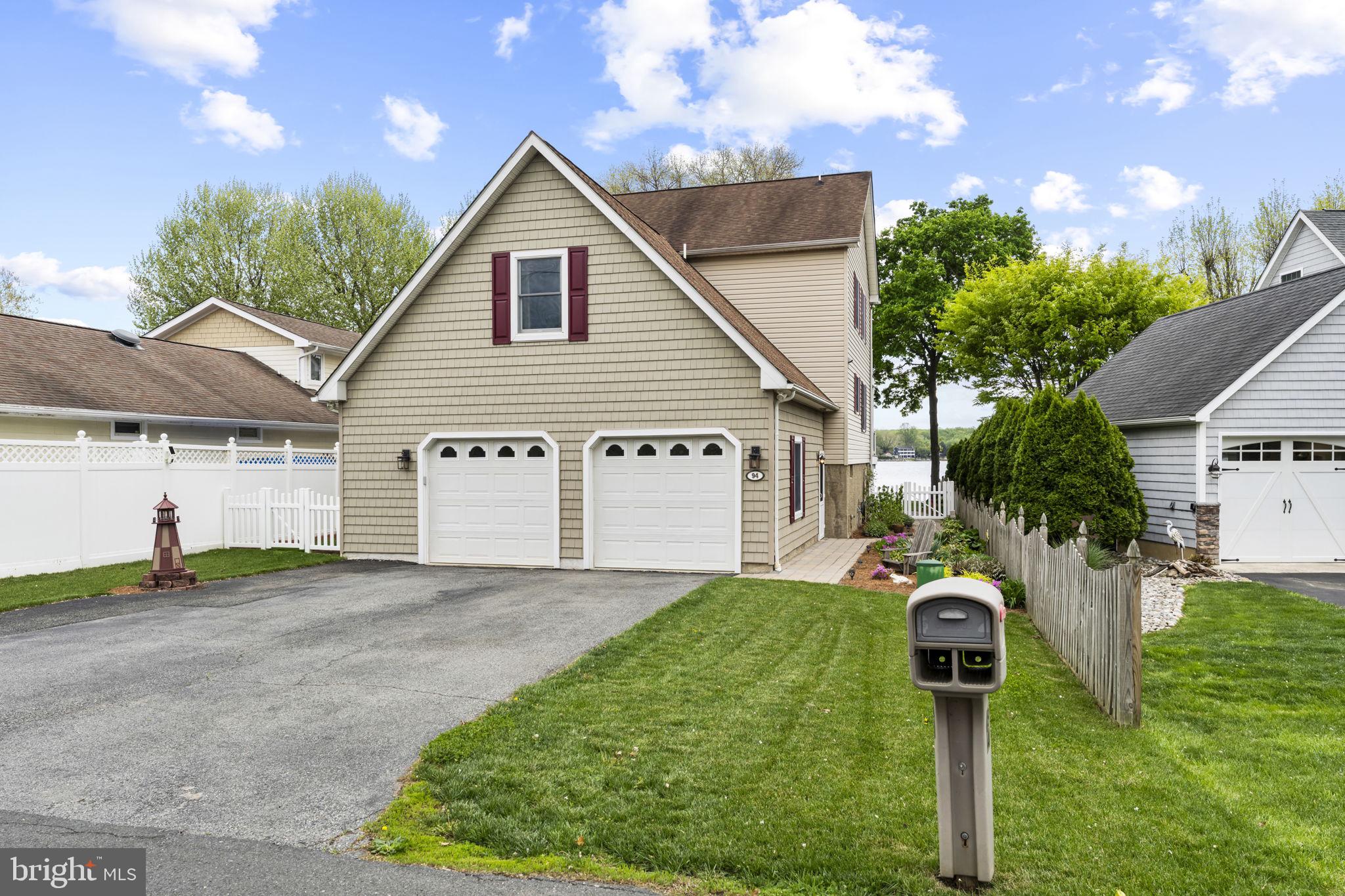 94 Crescent Lane Elkton, MD 21921 - Photo 5 of 59 a front view of a house with a yard and garage