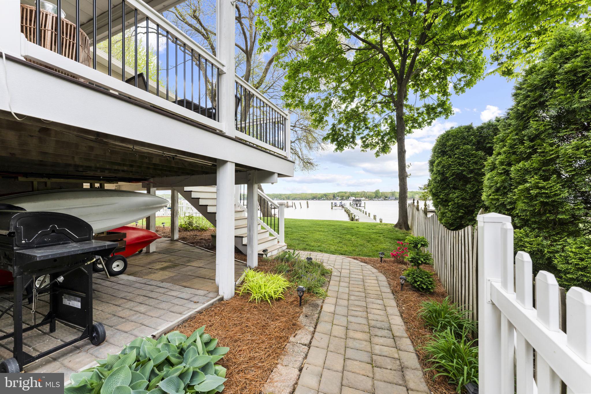 94 Crescent Lane Elkton, MD 21921 - Photo 54 of 59 a view of a patio with table and chairs potted plants with wooden fence
