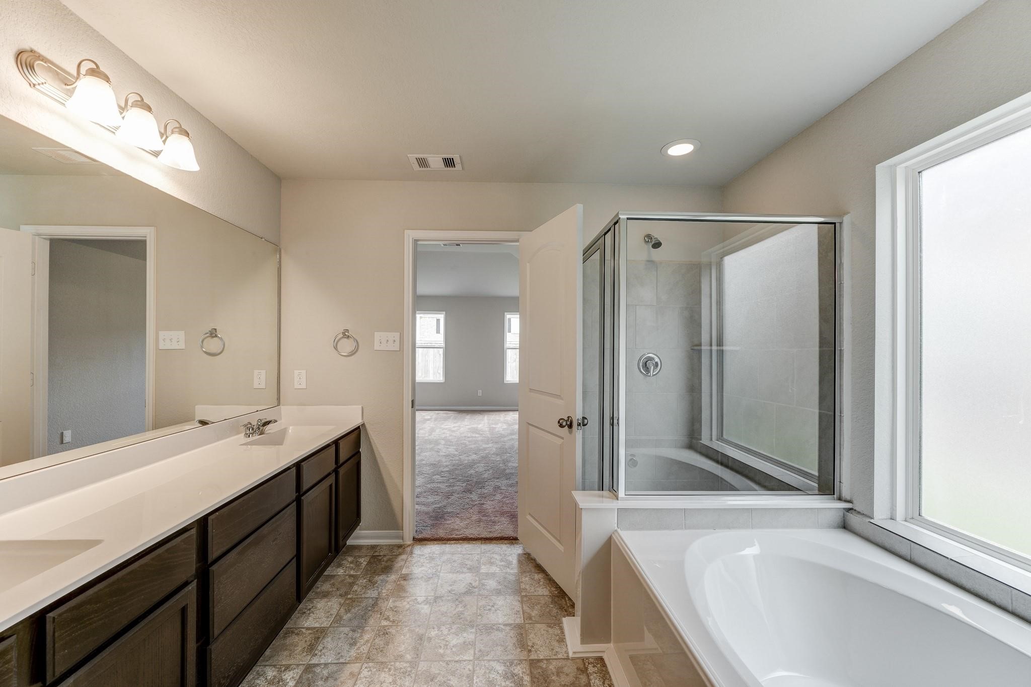 1015 Willowick Road Houston, TX 77090 - Photo 22 of 42 Bathroom #2 includes dual sinks and ample lighting, providing a bright and luxurious experience.