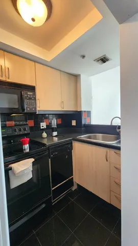 a kitchen with stainless steel appliances a sink stove and cabinets