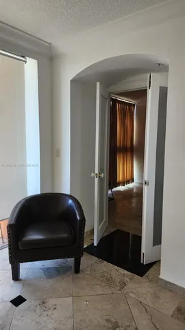 a bedroom with a bed and a chair