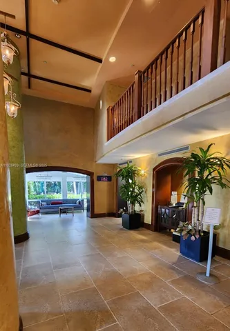 a lobby with furniture and a potted plant