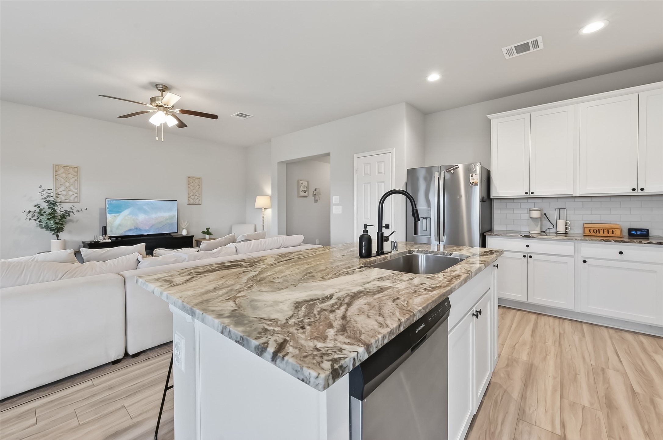 689 Red Elm Lane Conroe, TX 77304 - Photo 11 of 37 a kitchen with granite countertop a sink stove and refrigerator