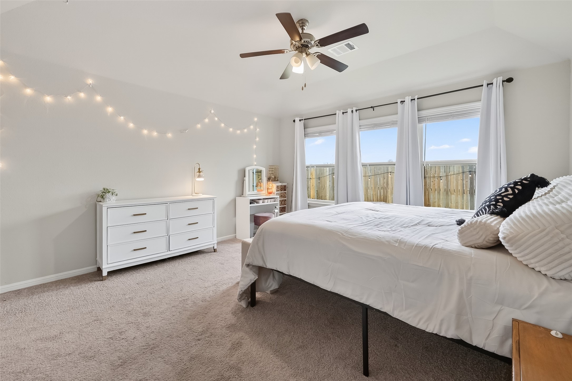 689 Red Elm Lane Conroe, TX 77304 - Photo 14 of 37 a bedroom with a bed a chandelier and a dresser