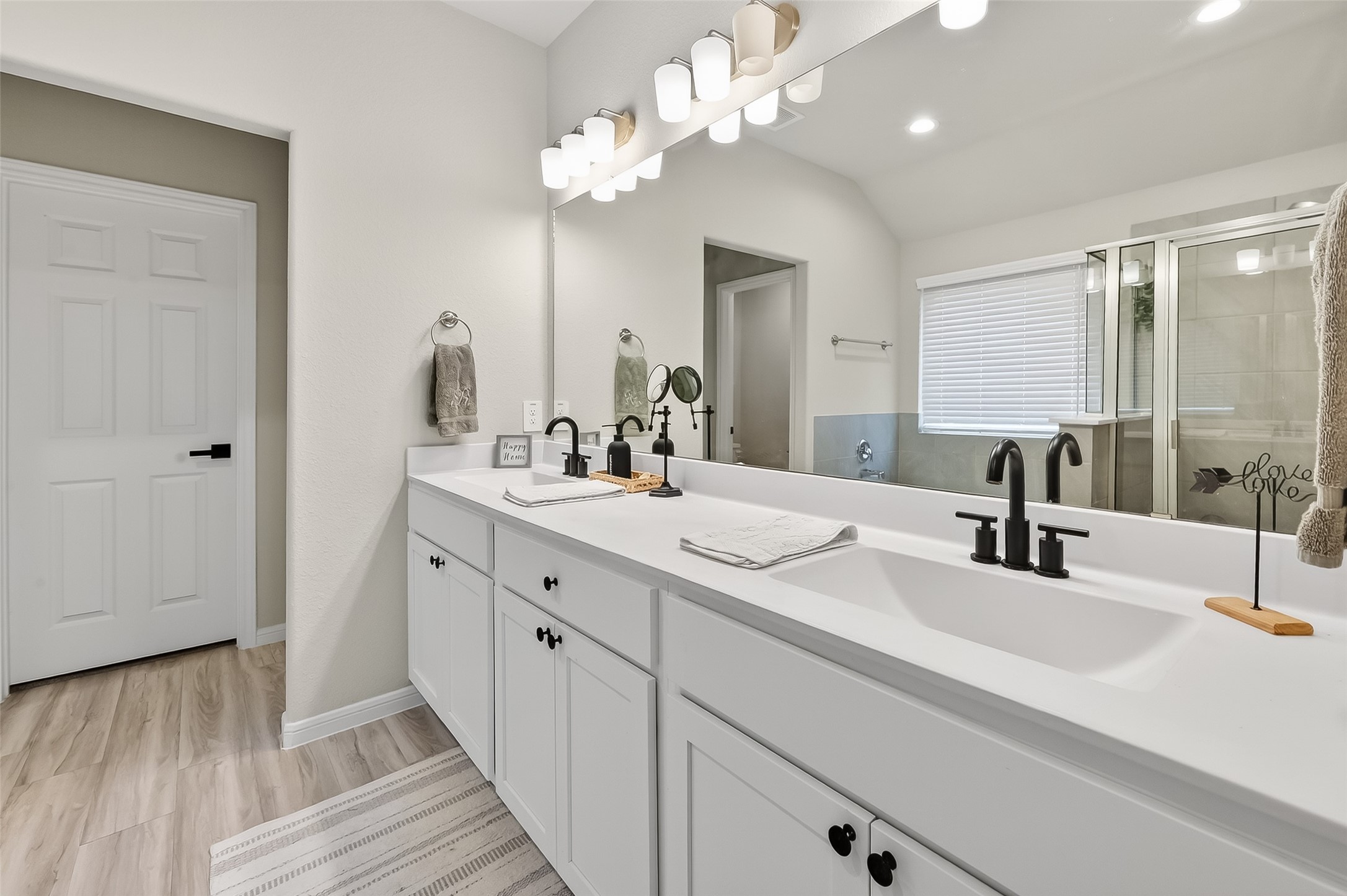 689 Red Elm Lane Conroe, TX 77304 - Photo 16 of 37 a bathroom with a double vanity sink and a mirror