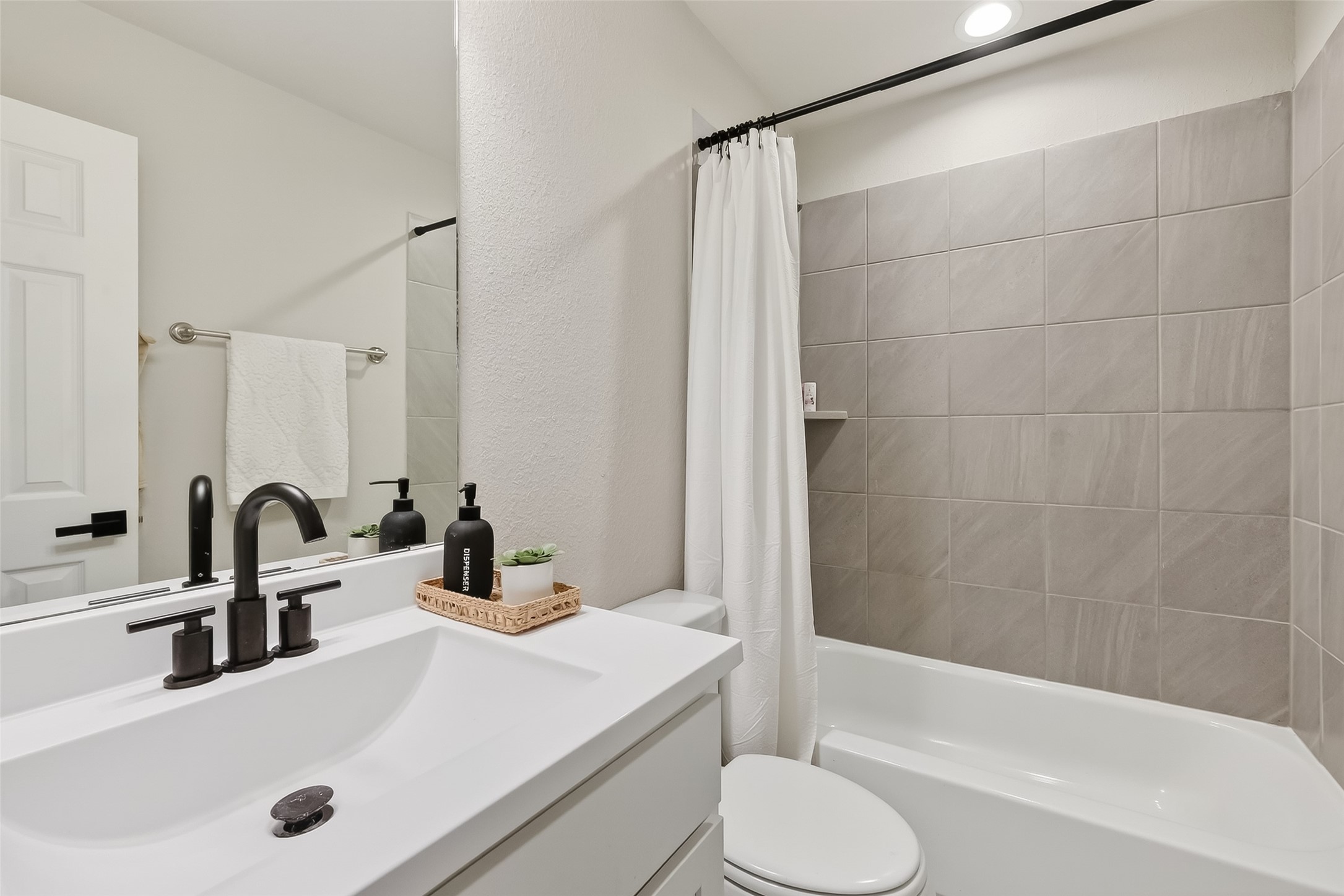 689 Red Elm Lane Conroe, TX 77304 - Photo 25 of 37 a bathroom with a sink and a tub