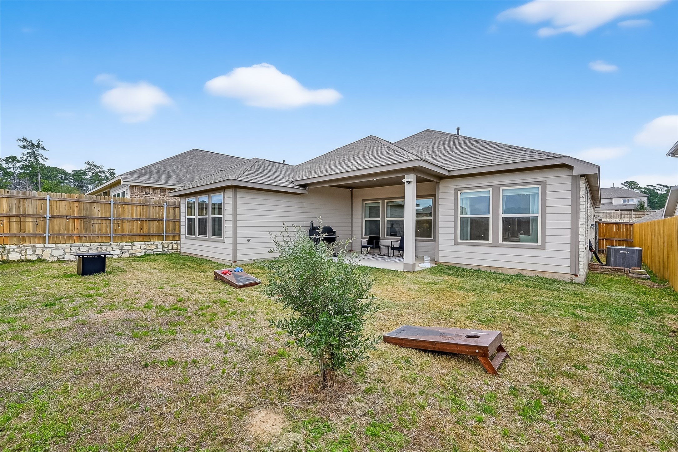 689 Red Elm Lane Conroe, TX 77304 - Photo 30 of 37 a view of a house with a backyard