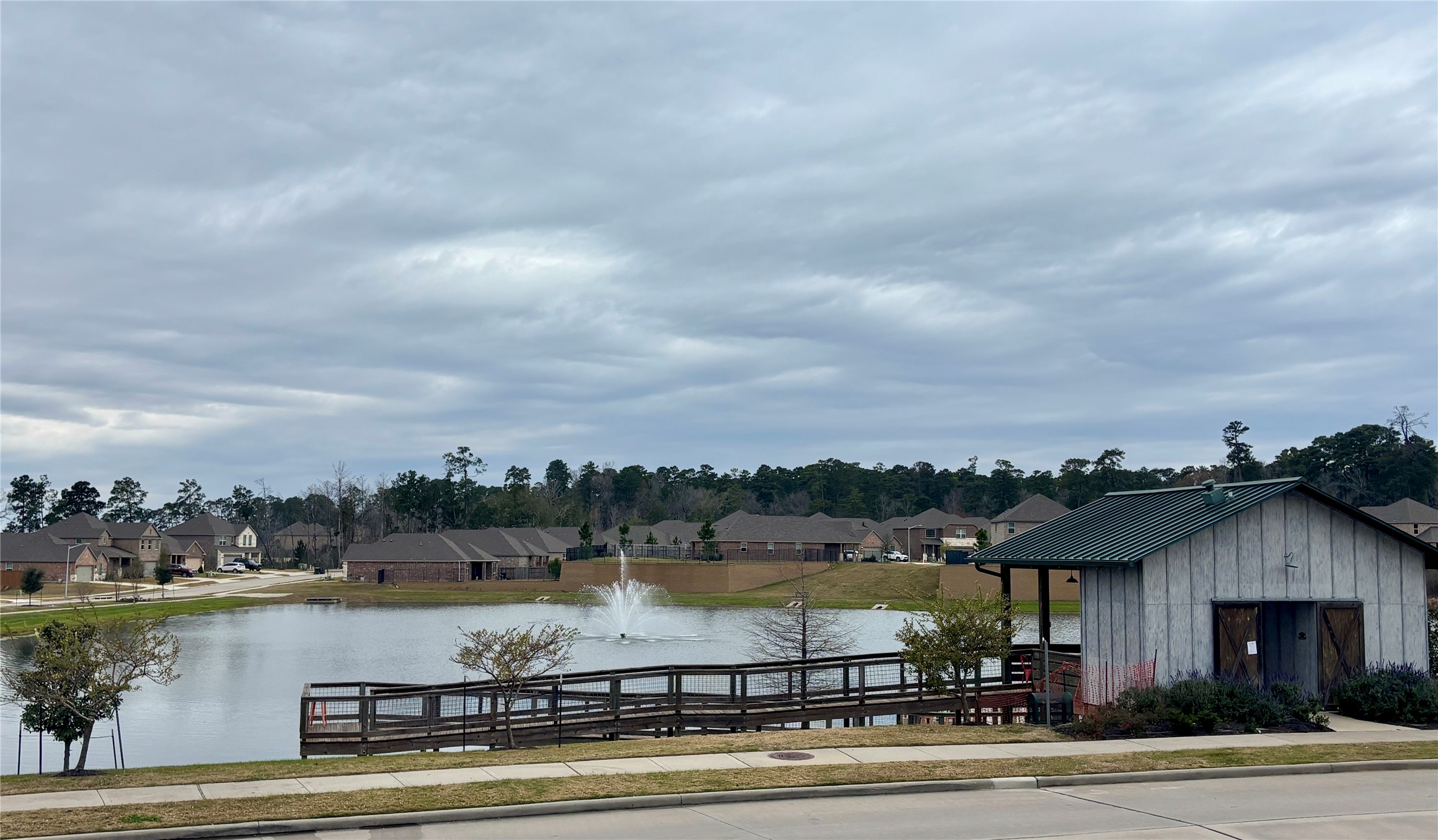 689 Red Elm Lane Conroe, TX 77304 - Photo 32 of 37 a view of a lake with a big yard and large trees