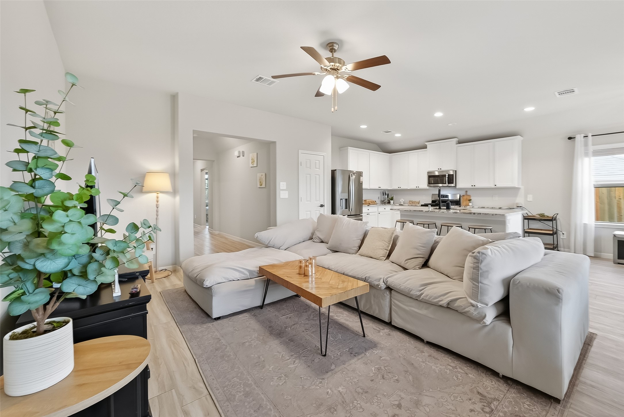 689 Red Elm Lane Conroe, TX 77304 - Photo 6 of 37 a living room with furniture kitchen and a chandelier