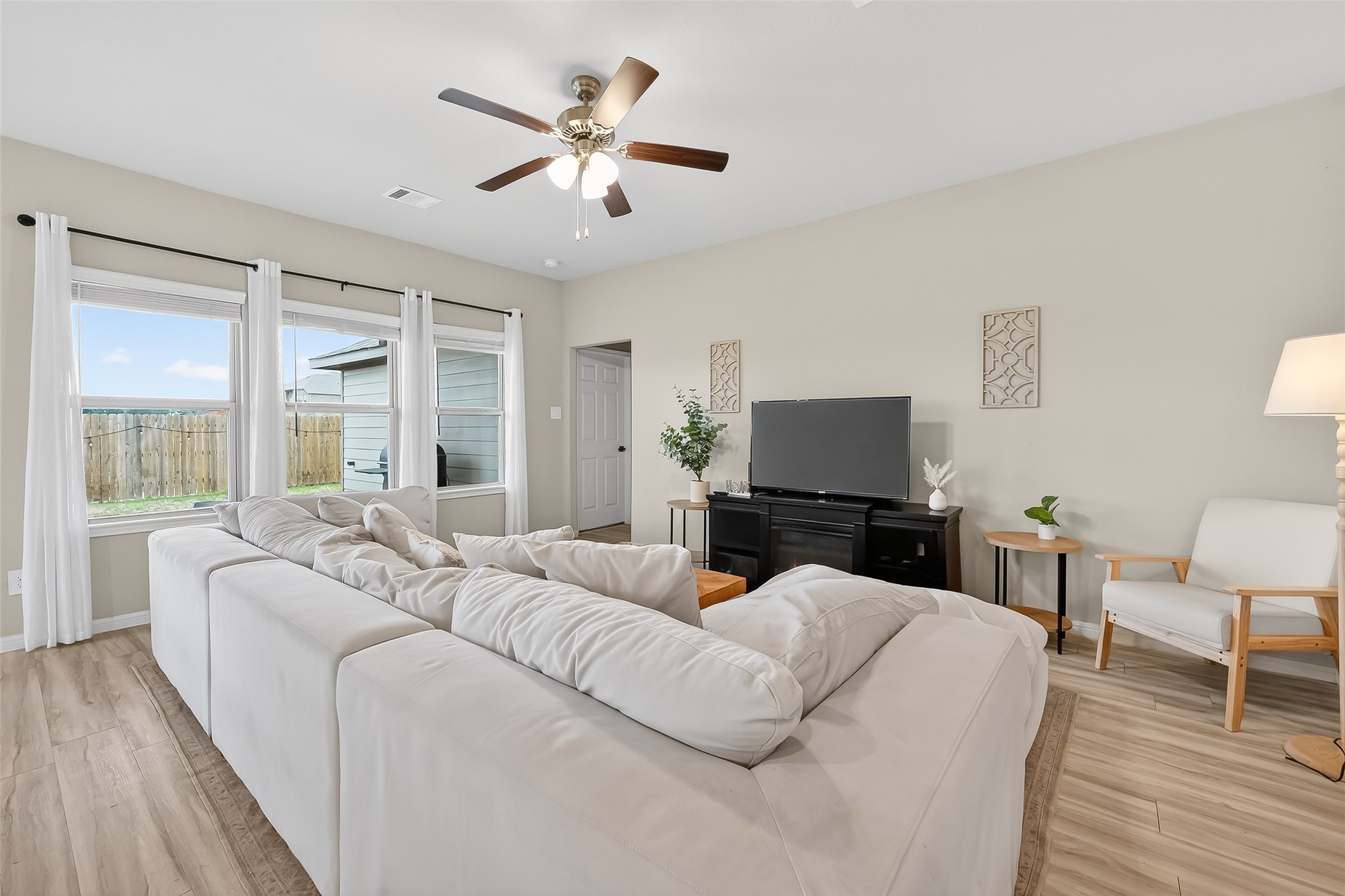 689 Red Elm Lane Conroe, TX 77304 - Photo 7 of 37 a living room with furniture a large window and a flat screen tv